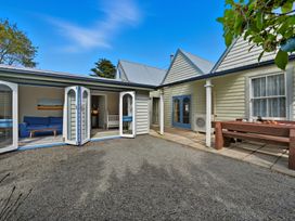 An outdoor area with a couch and coffee table at Akaroa Holiday Home