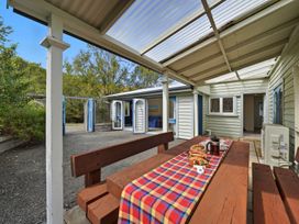 An outdoor dining area with a table and chairs at Akaroa Holiday Home 