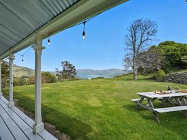 An outdoor area with a table under string lights at Akaroa Holiday Home