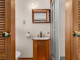 A bathroom with a sink and toilet at Mangawhai Heads in Mangawhai