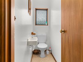 A bathroom with a toilet and sink at Mangawhai Heads in Mangawhai