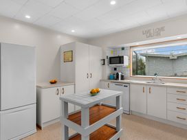A kitchen with cabinets and appliances at Mangawhai Heads in Mangawhai