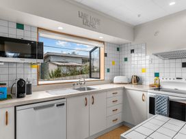 A kitchen with a window and appliances at Mangawhai Heads in Mangawhai