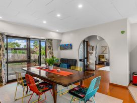 A dining room with a table and chairs at Mangawhai Heads in Mangawhai