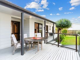 An outdoor area with a table and chairs at Mangawhai Heads in Mangawhai