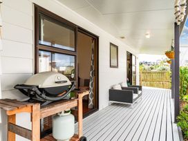 An outdoor area with a grill and seating at Mangawhai Heads in Mangawhai