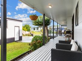 An outdoor area with seating and a storage shed at Mangawhai Heads in Mangawhai