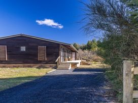 A house with a pathway and stairs at Railside Chalet - Raurimu Holiday Home in National Park