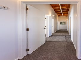 A hallway with doors and painting at Railside Chalet - Raurimu Holiday Home, National Park