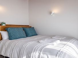 A bedroom with a bed and pillows at Railside Chalet - Raurimu Holiday Home National Park