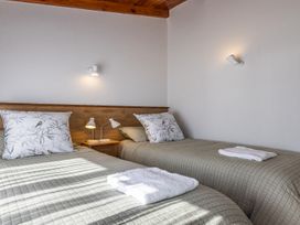 A bedroom with two beds and lamps at Railside Chalet - Raurimu Holiday Home National Park