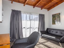A living room with a sofa and chair at Railside Chalet - Raurimu Holiday Home National Park