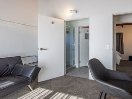 A bedroom with a sofa bed and a shower at Railside Chalet - Raurimu Holiday Home National Park