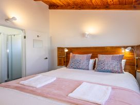 A bedroom with a double bed and shower at Railside Chalet - Raurimu Holiday Home National Park