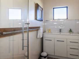 A bathroom with a shower and sink at Railside Chalet - Raurimu Holiday Home National Park