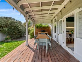 An outdoor dining area with a table and chairs at a residential property