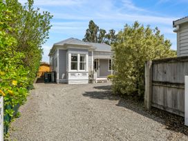 A house with a gravel driveway and garden at a property