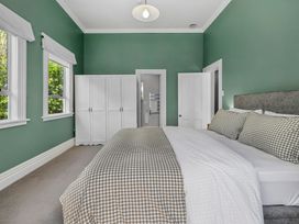 A bedroom with a bed and wardrobe at The Old Barn in Manchester