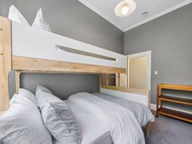 A bunk bed with a shelf in a bedroom at The Old Barn in Manchester