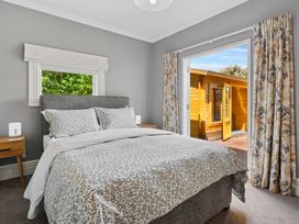 A bedroom with a bed and a door leading to an outdoor area at the property in 