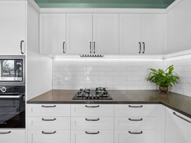A kitchen with gas cooktop and oven at the property location