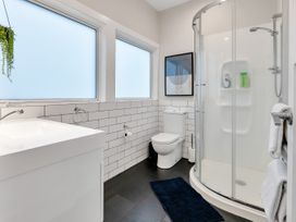 A bathroom with a shower, toilet, and sink at Chic Whangarei Retreat - 10 min Walk to CBD in Whangarei
