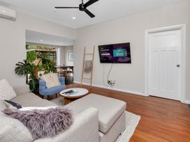 A living room with a sofa and television at Chic Whangarei Retreat - 10 min Walk to CBD, Whangarei