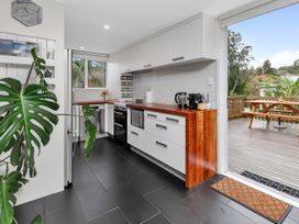 A kitchen with appliances and a counter at Chic Whangarei Retreat - 10 min Walk to CBD, Whangarei