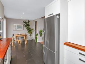 A kitchen with a table and chairs at Chic Whangarei Retreat - 10 min Walk to CBD Whangarei