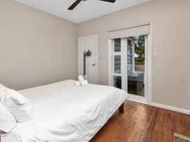 A bedroom with a bed and door leading to outdoor area at Chic Whangarei Retreat - 10 min Walk to CBD, Whangarei