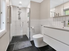 A bathroom with a shower and a toilet at Chic Whangarei Retreat - 10 min Walk to CBD, Whangarei