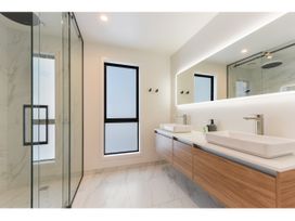 A bathroom with a shower, sinks and a mirror at Horizon View Retreat - Nelson Holiday Home