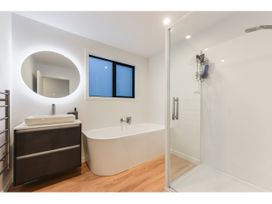A bathroom with a bathtub and shower at Horizon View Retreat - Nelson Holiday Home