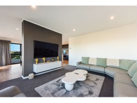 A living room with a sofa and coffee table at Horizon View Retreat - Nelson Holiday Home Nelson