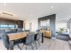 A dining room with a table and chairs at Horizon View Retreat - Nelson