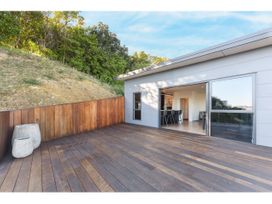 A deck with wooden flooring and a view of the interior at Horizon View Retreat - Nelson