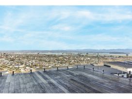 An outdoor deck with a view of the city and mountains at Horizon View Retreat - Nelson Holiday Home, Nelson