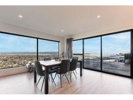 A dining room with a table and chairs at Horizon View Retreat - Nelson