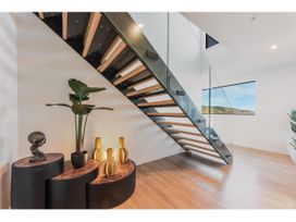 An entryway with a staircase and decorative items at Horizon View Retreat - Nelson Holiday Home