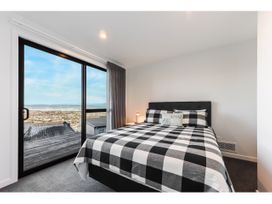 A bedroom with a bed and window at Horizon View Retreat - Nelson Holiday Home Nelson