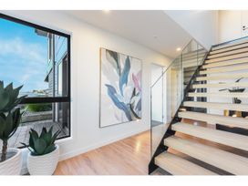 An entrance with a staircase and artwork at Horizon View Retreat - Nelson