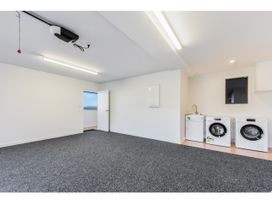 A laundry room with washing machine and dryer at Horizon View Retreat - Nelson Holiday Home