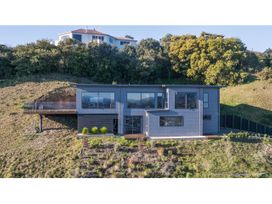 A house with a deck and garden at Horizon View Retreat - Nelson Holiday Home Nelson