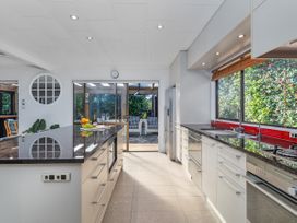 A kitchen with a countertop and island at Living The Dream - Matarangi Holiday Home Matarangi