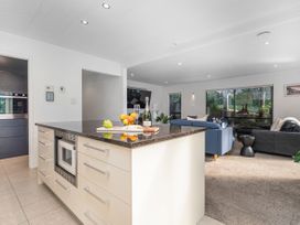 A kitchen with an island and fruit at Living The Dream - Matarangi Holiday Home, Matarangi