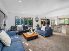 A living room with sofas and a coffee table at Living The Dream - Matarangi Holiday Home Matarangi