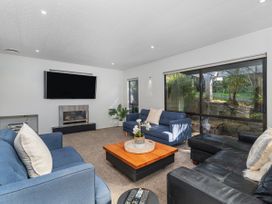 A living room with sofas and a coffee table at Living The Dream - Matarangi Holiday Home Matarangi