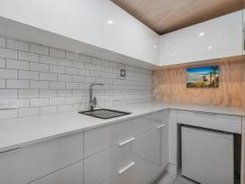 A kitchen with a sink and countertop at Living The Dream - Matarangi Holiday Home in Matarangi