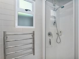A bathroom with a shower and towel rail at Living The Dream - Matarangi Holiday Home in Matarangi