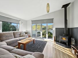 A living room with a sofa and coffee table at Birdlings Flat Banks Peninsula